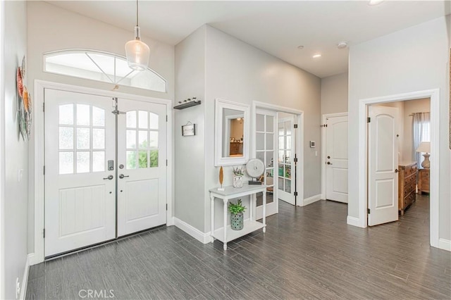 foyer with dark hardwood / wood-style flooring and french doors