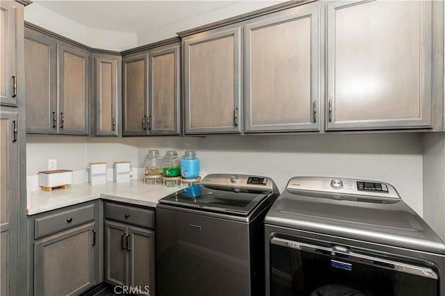 laundry room featuring cabinets and separate washer and dryer