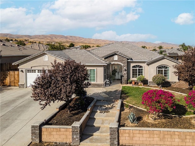 ranch-style house with a mountain view and a garage