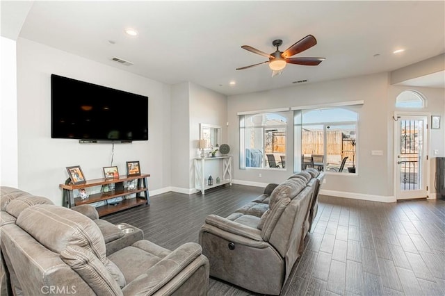 living room featuring dark hardwood / wood-style floors and ceiling fan