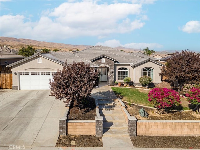 ranch-style home with a mountain view and a garage