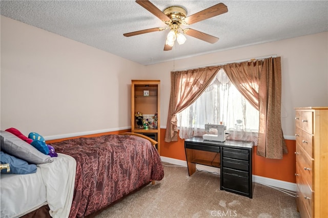 carpeted bedroom featuring a textured ceiling and ceiling fan