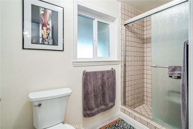 bathroom with walk in shower and toilet