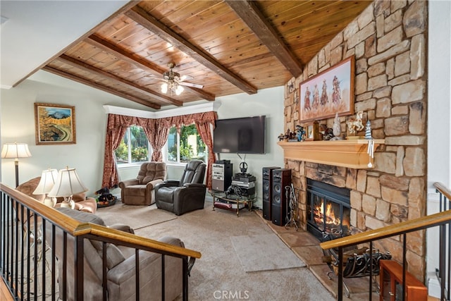 living room with ceiling fan, vaulted ceiling with beams, a fireplace, and wood ceiling