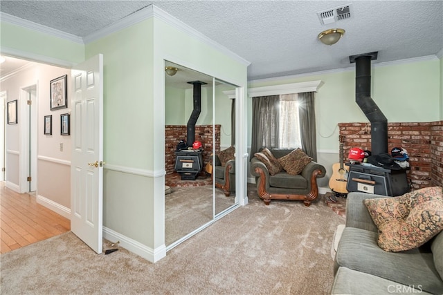 carpeted living room featuring ornamental molding and a textured ceiling