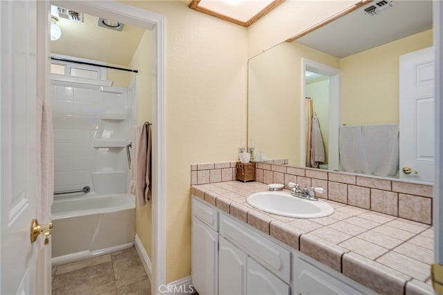 bathroom with bathtub / shower combination, tile patterned floors, and vanity