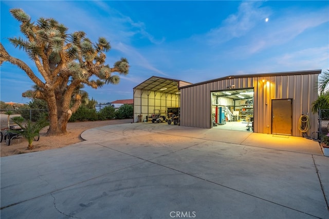 garage at dusk with a carport