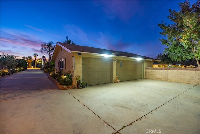 property exterior at dusk with a garage