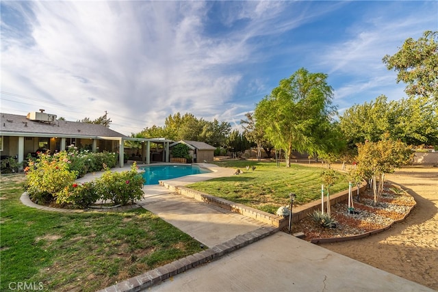 view of pool featuring a yard and a patio area