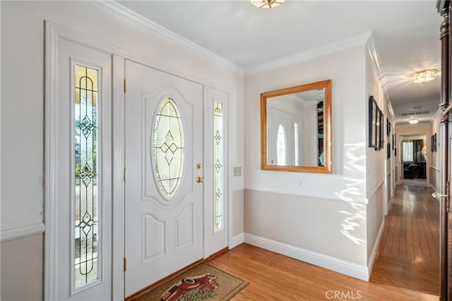 foyer featuring ornamental molding and hardwood / wood-style floors