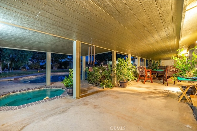 view of patio with a pool with hot tub