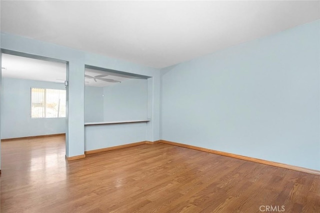 spare room with hardwood / wood-style flooring and ceiling fan