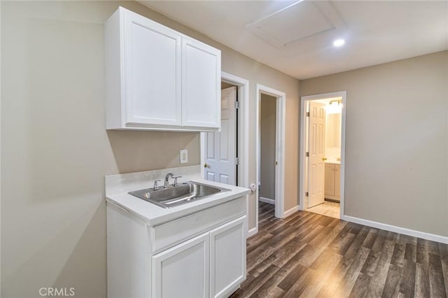 kitchen with white cabinetry, sink, and dark hardwood / wood-style floors