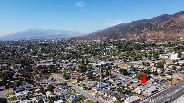 birds eye view of property with a mountain view