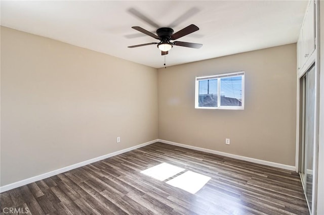 unfurnished room with ceiling fan and dark hardwood / wood-style floors