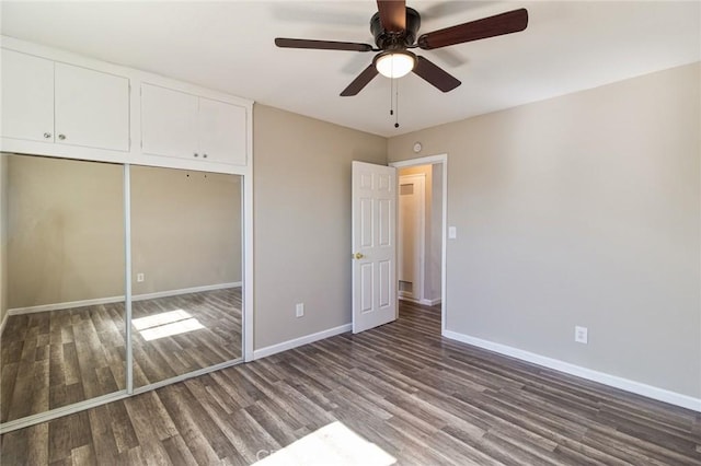 unfurnished bedroom featuring ceiling fan, a closet, and wood-type flooring