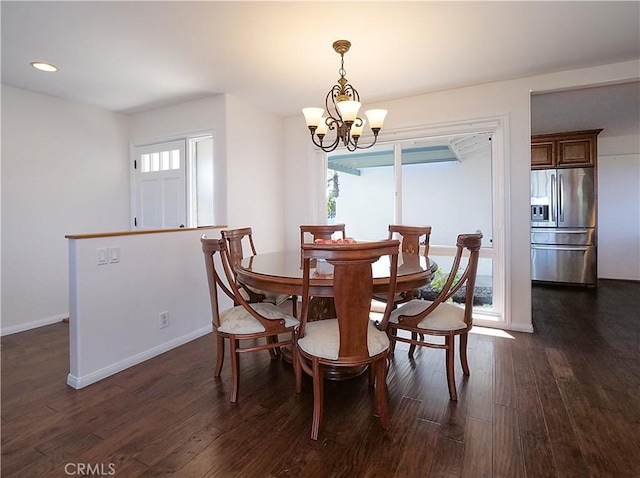 dining area with a chandelier and dark hardwood / wood-style floors