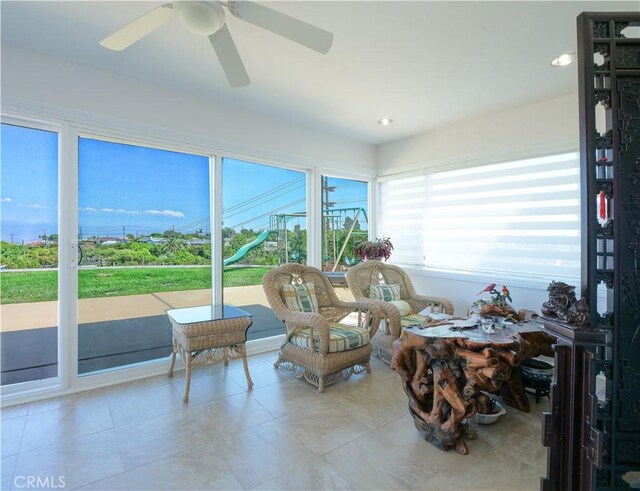 sunroom / solarium with ceiling fan and a wealth of natural light