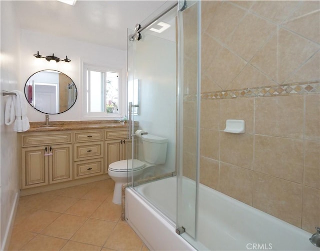 full bathroom featuring tile patterned floors, toilet, combined bath / shower with glass door, and vanity