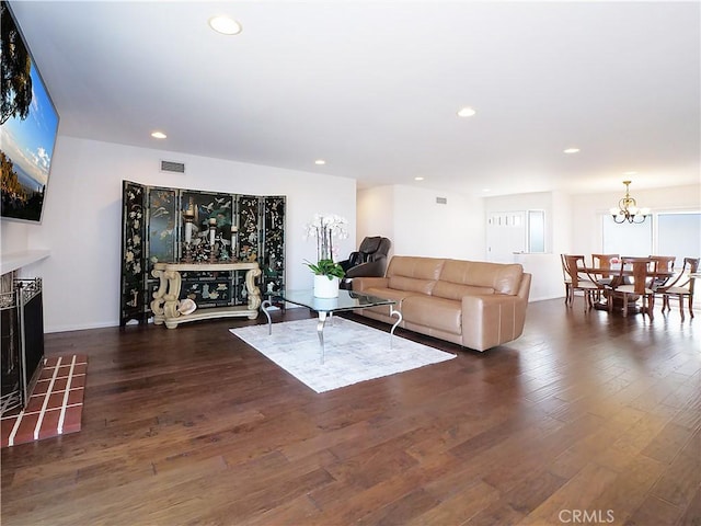 living room featuring dark hardwood / wood-style flooring and a notable chandelier