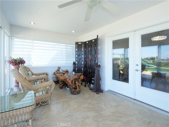 sitting room featuring ceiling fan and french doors