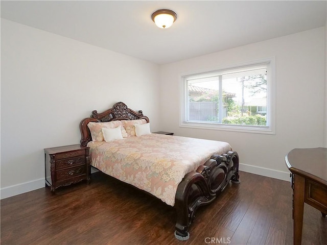 bedroom with dark hardwood / wood-style floors