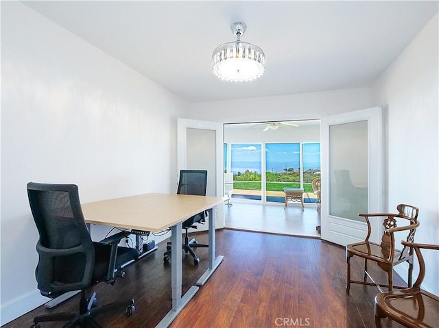 home office featuring ceiling fan and dark wood-type flooring