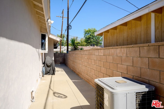 view of home's exterior with a patio and central AC unit