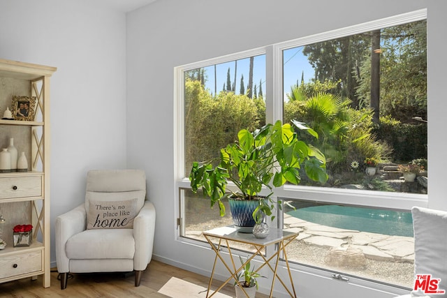 sitting room with plenty of natural light and wood-type flooring