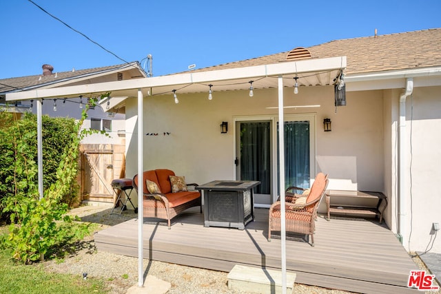 back of property with an outdoor living space and a deck