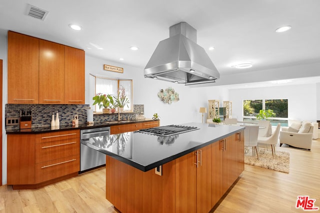 kitchen with a center island, sink, light hardwood / wood-style flooring, island exhaust hood, and stainless steel appliances