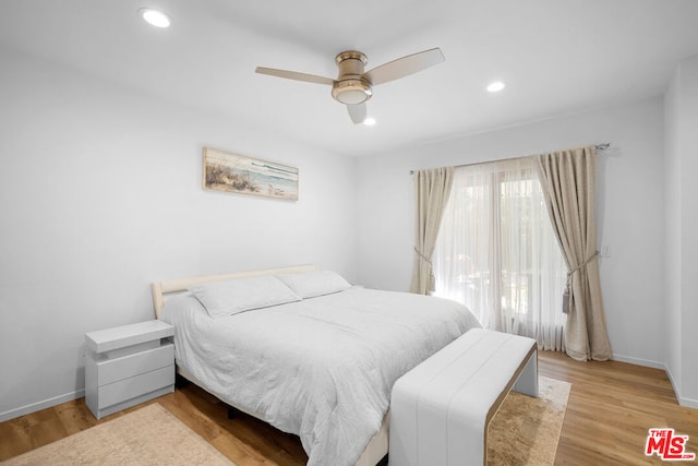 bedroom featuring light hardwood / wood-style floors and ceiling fan