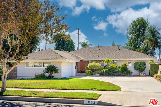 ranch-style house with a front yard and a garage