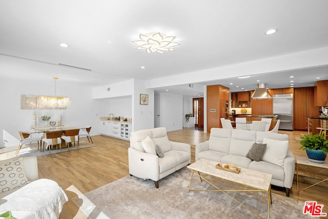 living room featuring light hardwood / wood-style flooring and a notable chandelier