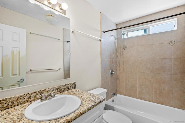 full bathroom featuring vanity, toilet, and tiled shower / bath combo