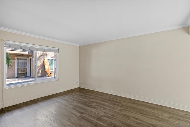 unfurnished room with ornamental molding and dark hardwood / wood-style floors