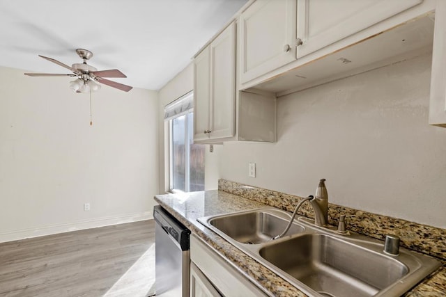 kitchen with white cabinetry, dishwasher, sink, light stone countertops, and light wood-type flooring