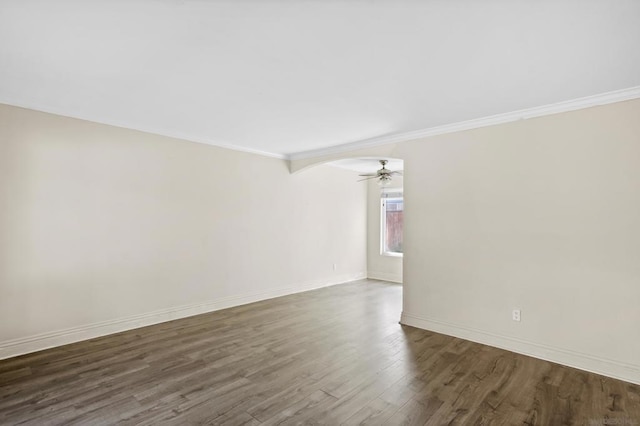 spare room with crown molding, ceiling fan, and dark hardwood / wood-style floors