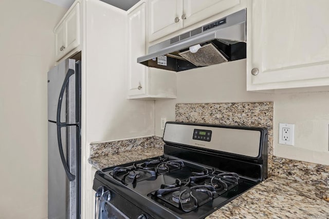 kitchen with white cabinetry, light stone countertops, stainless steel fridge, and range with gas stovetop