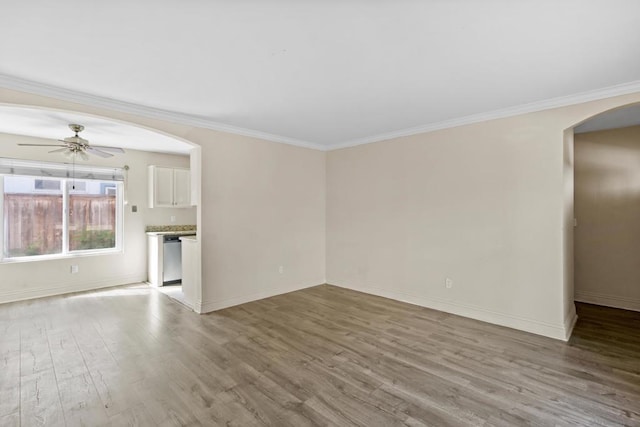 unfurnished living room featuring ceiling fan, ornamental molding, and light hardwood / wood-style floors