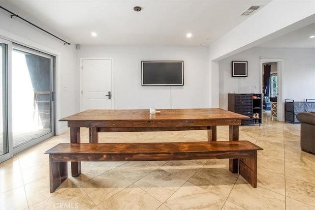 dining room featuring plenty of natural light and light tile patterned floors