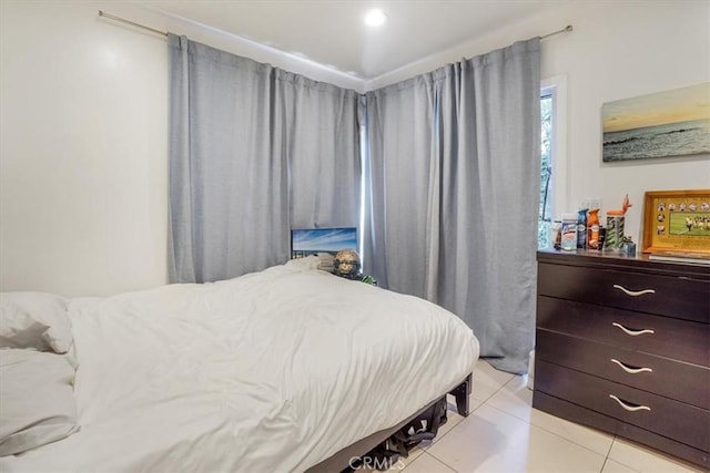 bedroom with light tile patterned floors