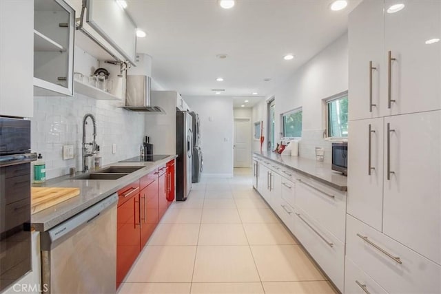 kitchen featuring decorative backsplash, sink, white cabinetry, and stainless steel appliances