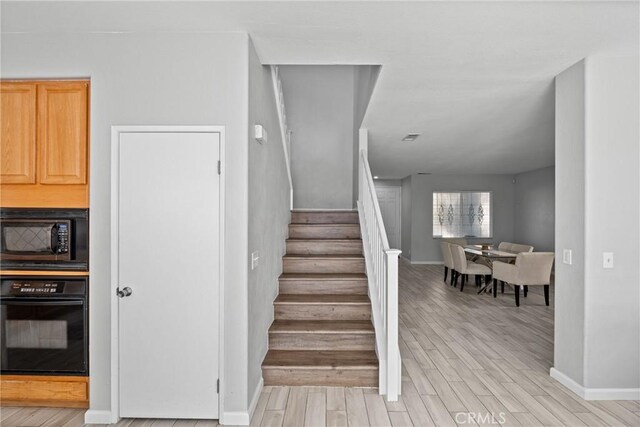 staircase featuring hardwood / wood-style floors