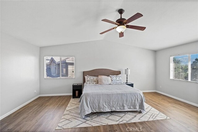 bedroom featuring light hardwood / wood-style floors, ceiling fan, and lofted ceiling