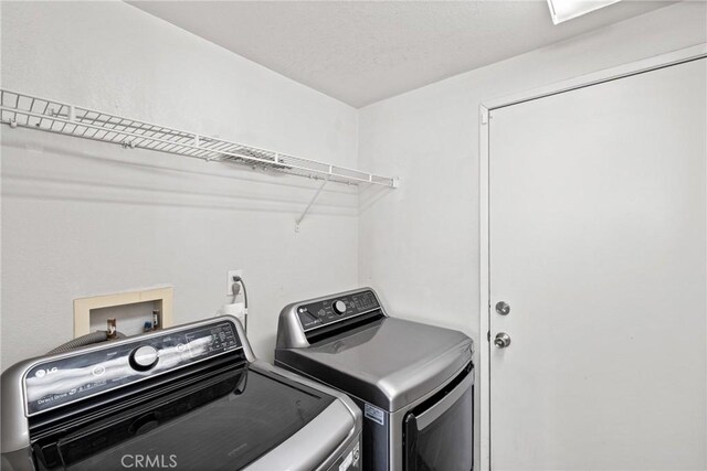 washroom featuring washer and dryer