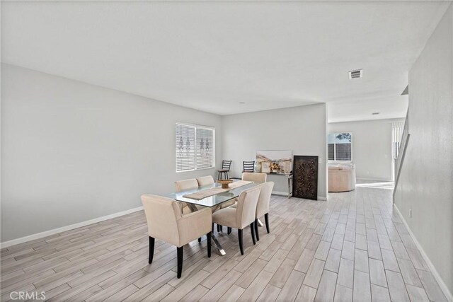 dining space with light hardwood / wood-style floors