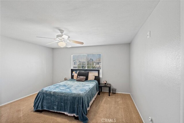 bedroom with ceiling fan and carpet