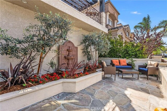 view of patio with an outdoor hangout area and a balcony