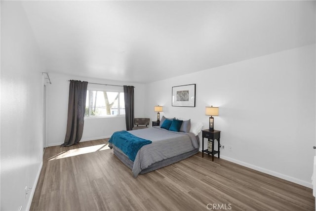 bedroom with hardwood / wood-style flooring